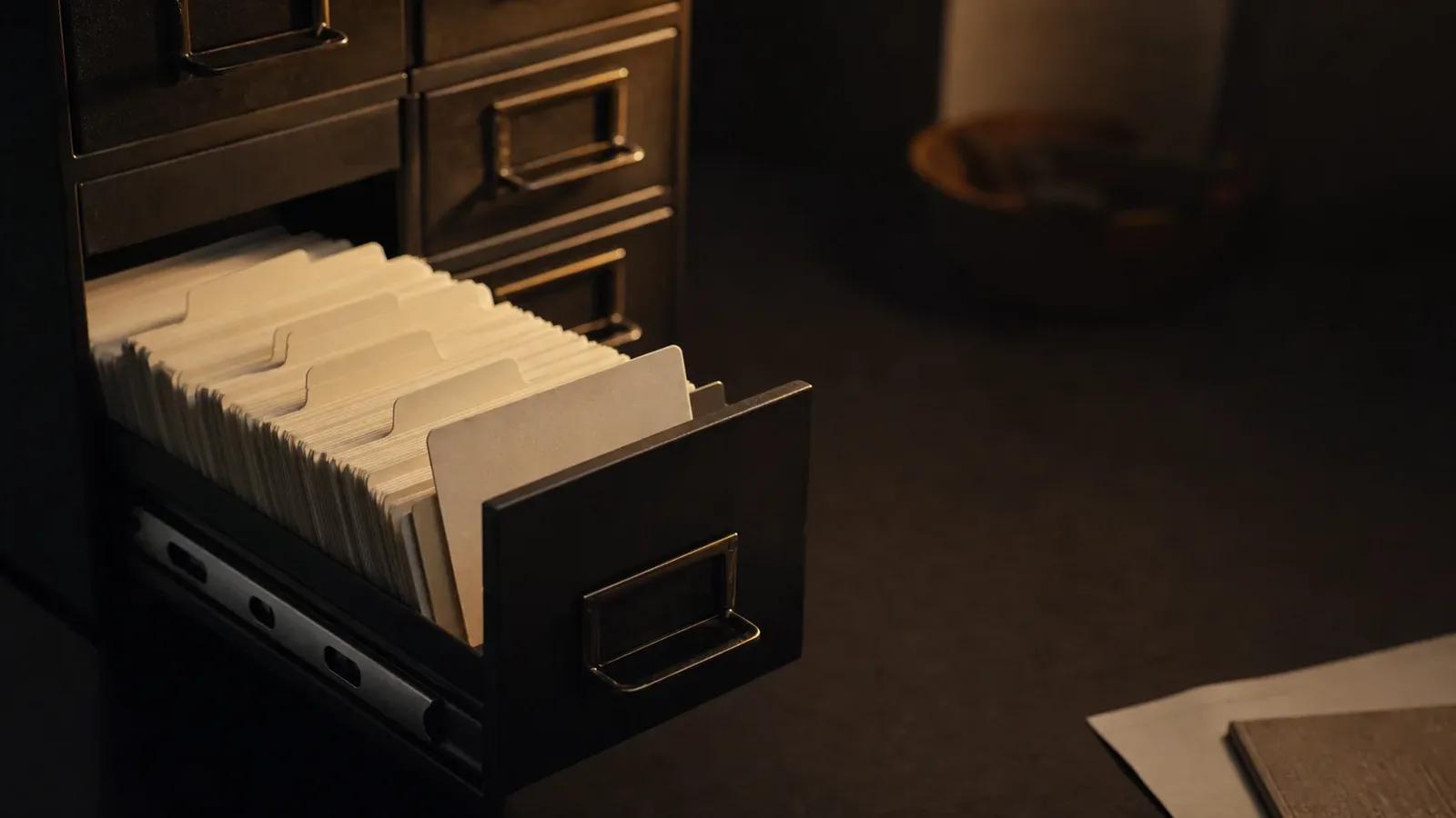 A filing-cabinet drawer of index cards pulled open